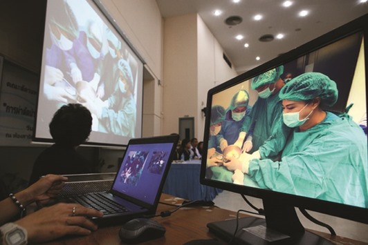 A screen show Thai veterinarians operate on Omsin at the Faculty of Veterinary Science, Chulalongkorn University in Bangkok.