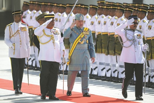 The 15th king of Malaysia, Sultan Mohamed V, inspects a ceremonial guard of honour during the opening session of the Parliament in Kuala Lumpur yesterday.