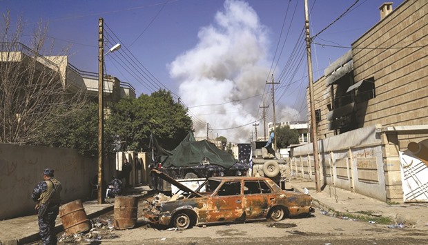 Smoke rises from a car bomb that exploded during a battle with Islamic State militants in Mosul yesterday.