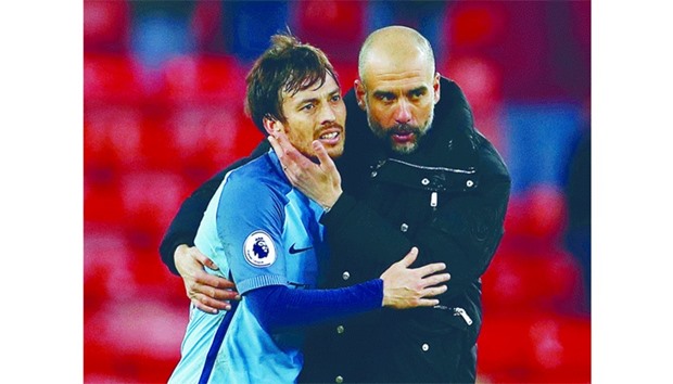 Manchester City manager Pep Guardiola (right) celebrates with David Silva after the win against Sunderland in a Premier League match on Sunday. (Reuters)