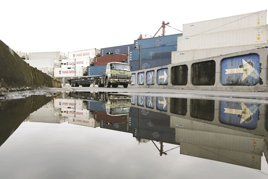 A truck is reflected in a rain puddle at Keelung port. In February, Taiwanu2019s exports jumped 27.7% from a year earlier, their fastest pace in six years.