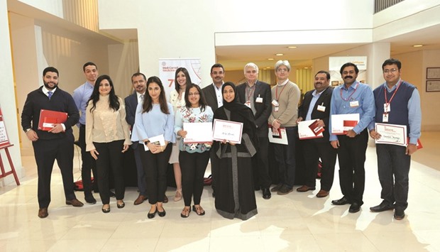 Faculty and staff pose with the winners and runners-up in the poster exhibition.