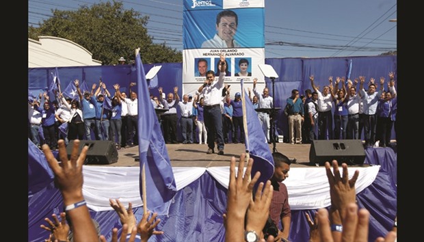 Honduran President Juan Orlando Hernandez, who is running to be the presidential candidate for the ruling Partido Nacional (National Party), delivers a speech to supporters during a rally ahead of the March 12 primary elections in Tegucigalpa, Honduras.