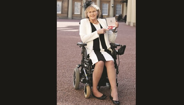 Para-equestrian Anne Dunham poses with her medal after she was appointed a Officer of the Order of the British Empire (OBE) for services to para-equestrianism during an Investiture ceremony at Buckingham Palace, London, yesterday.