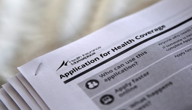 Applications are seen at a rally held by supporters of the Affordable Care Act