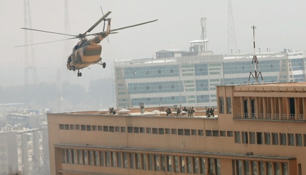Afghan National Army (ANA) soldiers descend from helicopter on a roof of a military hospital during gunfire and blast in Kabul, Afghanistan.