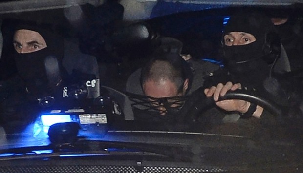 French police escort suspect Hubert Caouissin to the home of Lydie Troadec