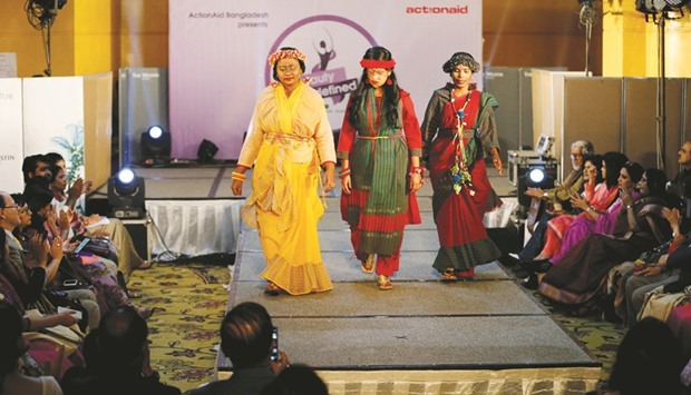 Acid attack survivors walk on the ramp as they participate in a fashion show titled u201cBeauty Redefinedu201d organised by ActionAid Bangladesh in Dhaka.