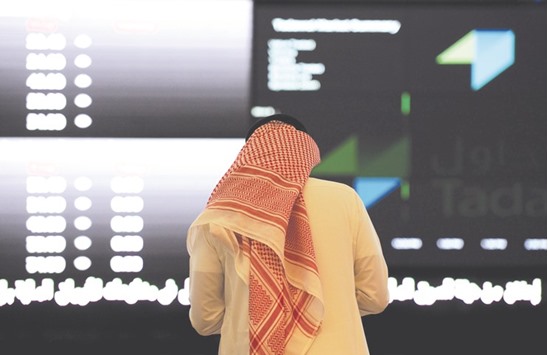 A Saudi investor monitors share prices at the Saudi Stock Exchange, or Tadawul, in the capital Riyadh (file). Most Saudi Arabian bank stocks fell on Wednesday amid concerns that a domestic sukuk sale could drain liquidity from the countryu2019s banking system.
