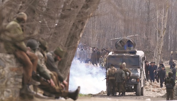 A teenage boy and two militants were killed in a firefight with government forces in Kashmir yesterday that brought hundreds of local villagers out onto the streets in defiance of police orders.