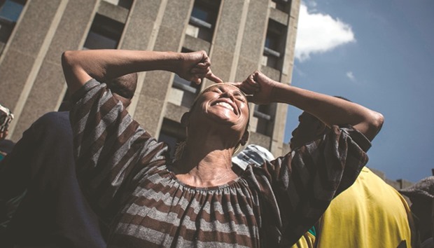 A protester reacts as community members from Reigers Park protest outside the municipal offices over service delivery and housing issues in Boksburg, South Africa.