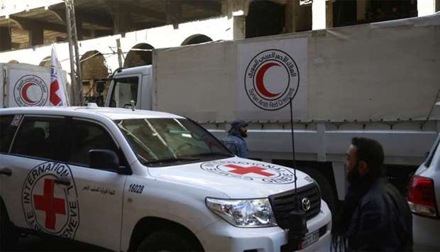 International Red Cross (CIRC) and Red Crescent aid trucks are seen in the besieged town of Douma, Eastern Ghouta