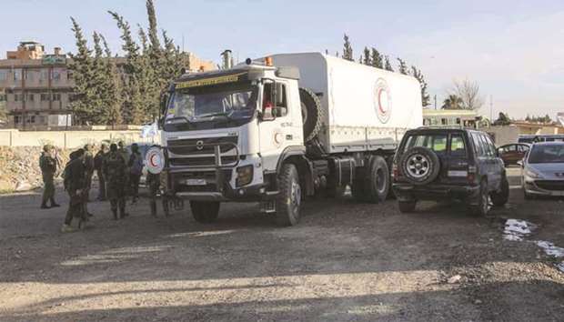 A picture taken yesterday shows a Syrian Red Crescent humanitarian aid truck waiting to pass through the Wafideen checkpoint on the outskirts of the capital Damascus into the rebel-held Eastern Ghouta enclave.