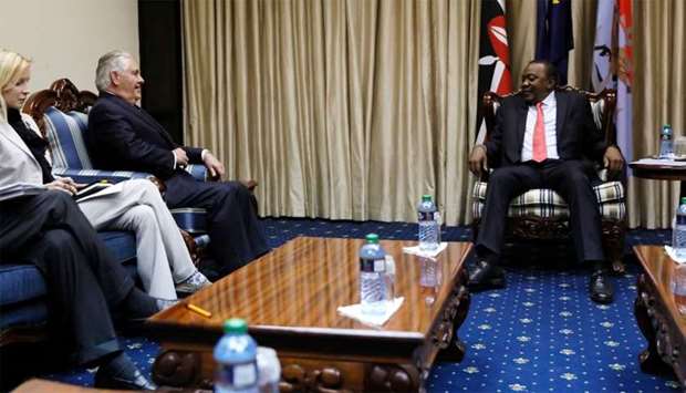 Kenya's President Uhuru Kenyatta (R) greets US Secretary of State Rex Tillerson, flanked by his chief of staff Margaret Peterlin (L), at the State House in Nairobi, Kenya