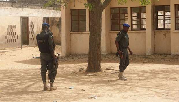 Policemen stand on guard at the premises of Government Girls Technical College at Dapchi town in northern Nigeria