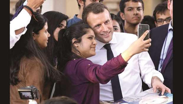 French President Emmanuel Macron poses for a selfie at Bikaner House in New Delhi yesterday. Macron said he wanted his country to be Indiau2019s best partner in Europe.