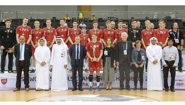 Austriau2019s boys team poses with the winnersu2019 trophy, Rabea al-Kaabi, President of the School Sports Federation and Chairman of the Organising Committee, and other officials, after they beat Germany in the final of the ISF World Schools Handball Championship at the Ali Bin Hamad Al Attiyah Arena yesterday. PICTURES: Thajudheen