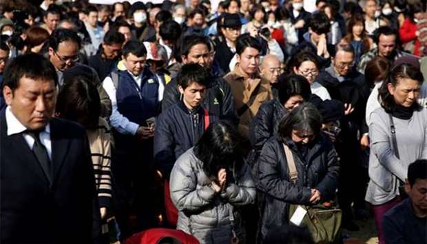 People offering a moment of silence at 2:46 pm, the time when the magnitude 9.0 earthquake struck off Japan\'s coast in 2011, during a rally in Tokyo on Sunday.