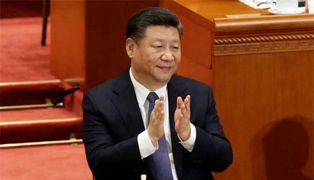 Chinese President Xi Jinping applauds after the parliament passed a constitutional amendment lifting presidential term limit, at the Great Hall of the People in Beijing on Sunday.