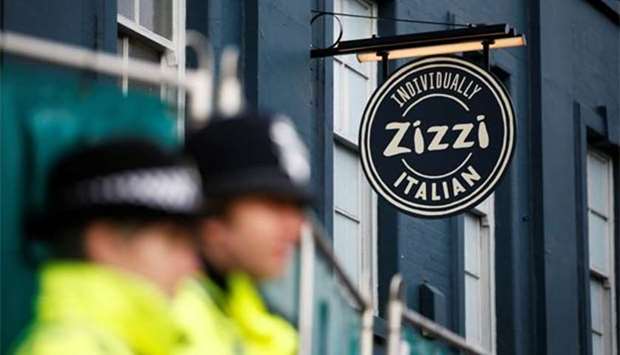 Police stand on duty outside a restaurant which has been secured as part of the investigation into the poisoning of former Russian inteligence agent Sergei Skripal and his daughter Yulia, in Salisbury on Sunday.