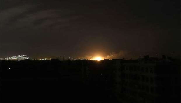 An explosion, from a Syrian government air strike, illuminates Arbin in Eastern Ghouta.