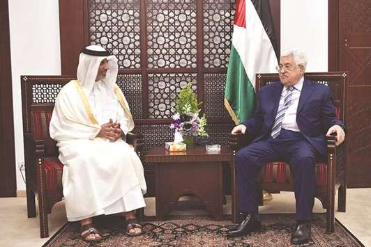 Palestine President Mahmoud Abbas (right) with President of the Qatar Football Association Sheikh Hamad bin Khalifa bin Ahmed al-Thani in Ramallah yesterday.