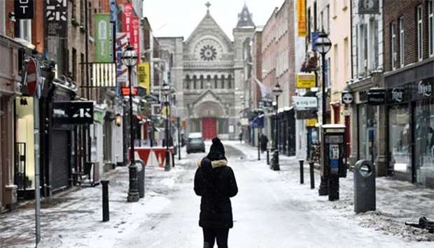 A woman looks at the empty streets in the centre of Dublin on Thursday.