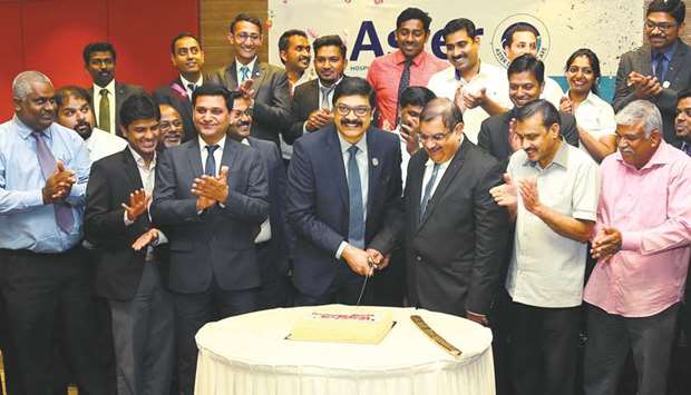 Dr Sameer Moopen with other Aster officials and staff cutting a cake to mark the 15th anniversary of the group. PICTURE: Ram Chand