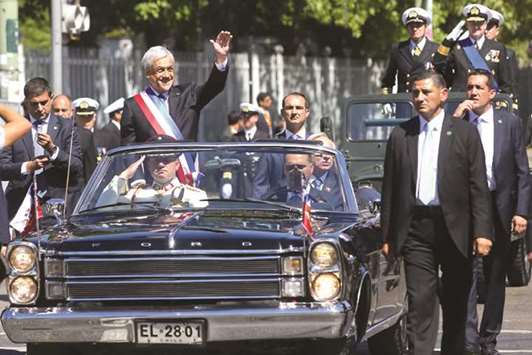 Chileu2019s newly sworn in President Sebastian Pinera waves as he leaves after his inauguration at the Congress in Valparaiso, Chile, yesterday.