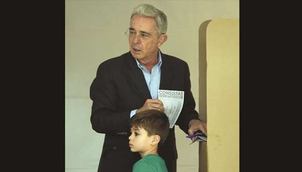 Colombian former president and current senator Alvaro Uribe votes at a polling station in Bogota yesterday.
