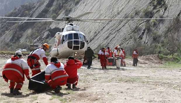 Members of the Iranian Red Crescent carry caskets with the bodies of victims of a Turkish plane that crashed, in Shahre Kord, southwestern Iran on Monday.