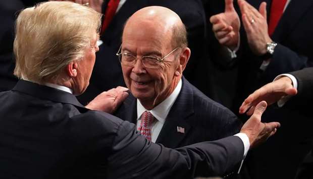 US President Donald J. Trump greets Secretary of Commerce Wilbur Ross as he arrives in the chamber of the US House of Representatives