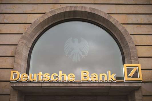 A sign is seen above the entrance to a Deutsche Bank branch in Frankfurt. The German lender plans to raise as much as $2.2bn in an initial public offering of its asset-management unit, a key pillar of the banku2019s turnaround strategy.