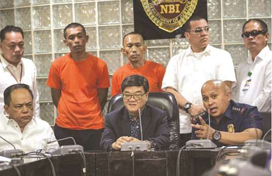 National Police Chief Director General, Ronald Dela Rosa (right, seated) speaks, while Justice Secretary Vitaliano Aguirre (centre) and National Bureau of Investigation Chief Dante Gierran (left) listen during the presentation of suspected militants, H Abdullah and Jimmy Bla at the National Bureau of Investigation headquarters in Manila, yesterday.