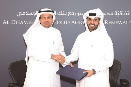 Dr al-Shaibei with al-Khalifa after signing the agreement under u2018Al Dhameenu201d programme.