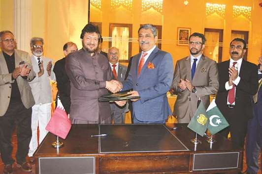Anwar and Khan shaking hands after signing the MoU recently.