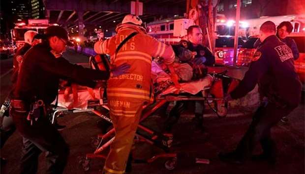 Paramedics and members of the fire department perform CPR on a victim of a helicopter that crashed into the East River in New York on Sunday.