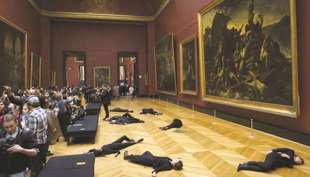 Members of the environmental activist group u2018350.orgu2019 lie on the floor in front of Theodore Gericaultu2019s painting The Raft of the Medusa at the Louvre museum in Paris.