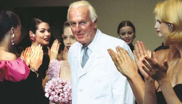 Givenchy is applauded by models after presenting his last high fashion collection on July 11, 1995 in Paris.