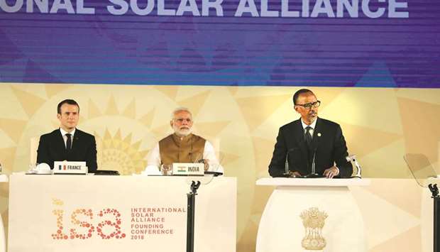 Rwandau2019s President Paul Kagame delivers his speech next to French President Emmanuel Macron and Indian Prime Minister Narendra Modi during the founding conference of the International Solar Alliance in New Delhi on March 11, 2018. The International Solar Alliance (ISA) organises more than 121 u201csunshineu201d countries that are situated or have territory between the Tropic of Cancer and the Tropic of Capricorn, with the aim of boosting solar energy output in an effort to reduce global dependence on fossil fuels.