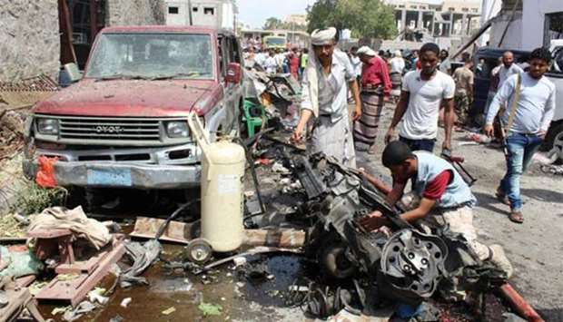 Yemenis inspecting debris and car wreckage in the aftermath of an explosion in Aden on Tuesday.