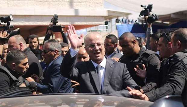 Palestinian Prime Minister Rami Hamdallah waves to the crowd upon his arrival in Gaza City on Tuesday.