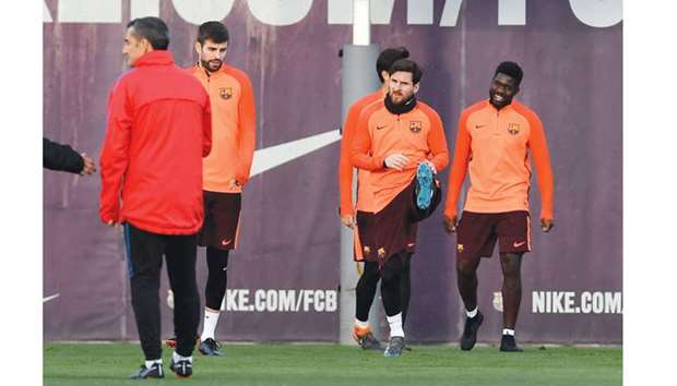 Barcelonau2019s defender Gerard Pique (second left), forward Lionel Messi (second right) and defender Samuel Umtiti (right) take part in a training session at the Joan Gamper Sports Centre in Sant Joan Despi near Barcelona on the eve of the UEFA Champions League round of 16 second leg match against Chelsea. (AFP)