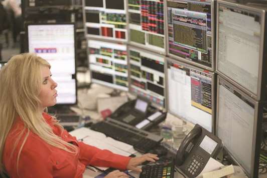 A trader is seen at the London Stock Exchange. The FTSE 100 lost 1.1% to 7,138.78 points yesterday.