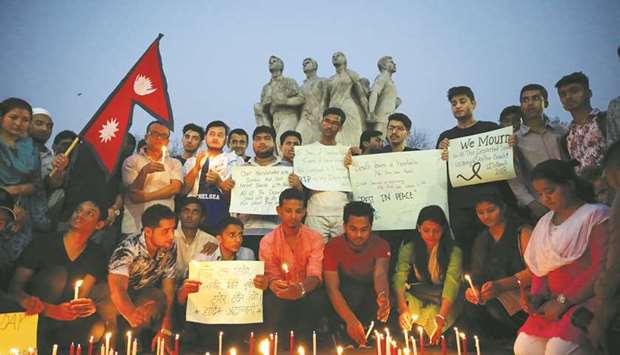 Nepali students of University of Dhaka light candles in memory of the victims of the US-Bangla aircraft crash in Nepal, in Dhaka, yesterday.