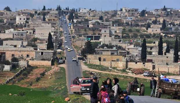 Civilans fleeing Afrin after Turkey said its army and allied rebels surrounded the Kurdish city in northern Syria, pass through az-Ziyarah in the government-controlled part of the northern Aleppo province as they head to seek refuge in the town of Nubol, 26 kms northwest of Aleppo city.