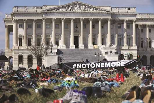 The 7,000 pairs of shoes, representing the children killed by gun violence since the mass shooting at Sandy Hook Elementary School in 2012, are spread out on the lawn on the east side of the US Capitol in Washington, DC.