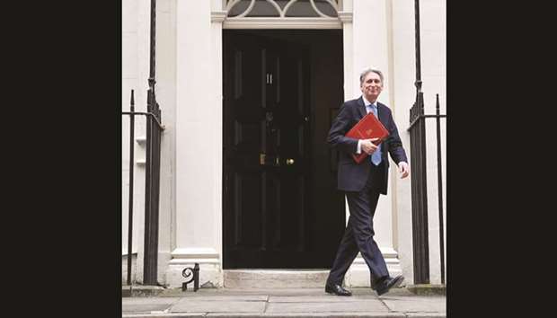  Chancellor of the Exchequer Philip Hammond leaves 11 Downing Street to deliver his half-yearly update on the public finances, in London, yesterday.