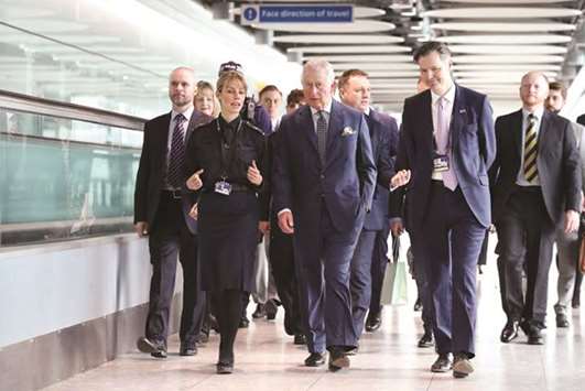 Prince Charles talks with UK Border Force officers during a visit to Heathrow Airport in west London yesterday.