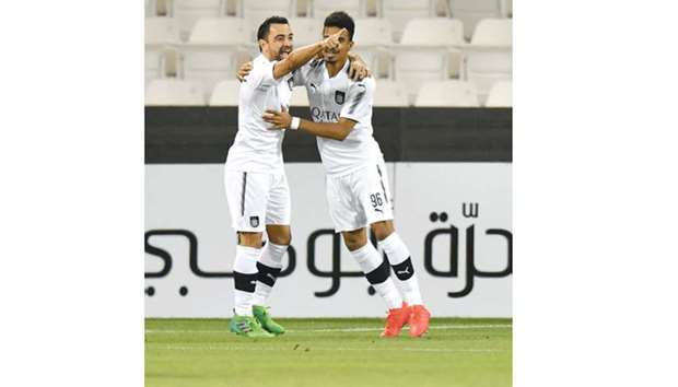 Al Sadd captain Xavi (L) celebrates with Akram Afif after scoring the first goal against Uzbekistanu2019s Nasaf in Doha yesterday. PICTURE: Noushad Thekkayil